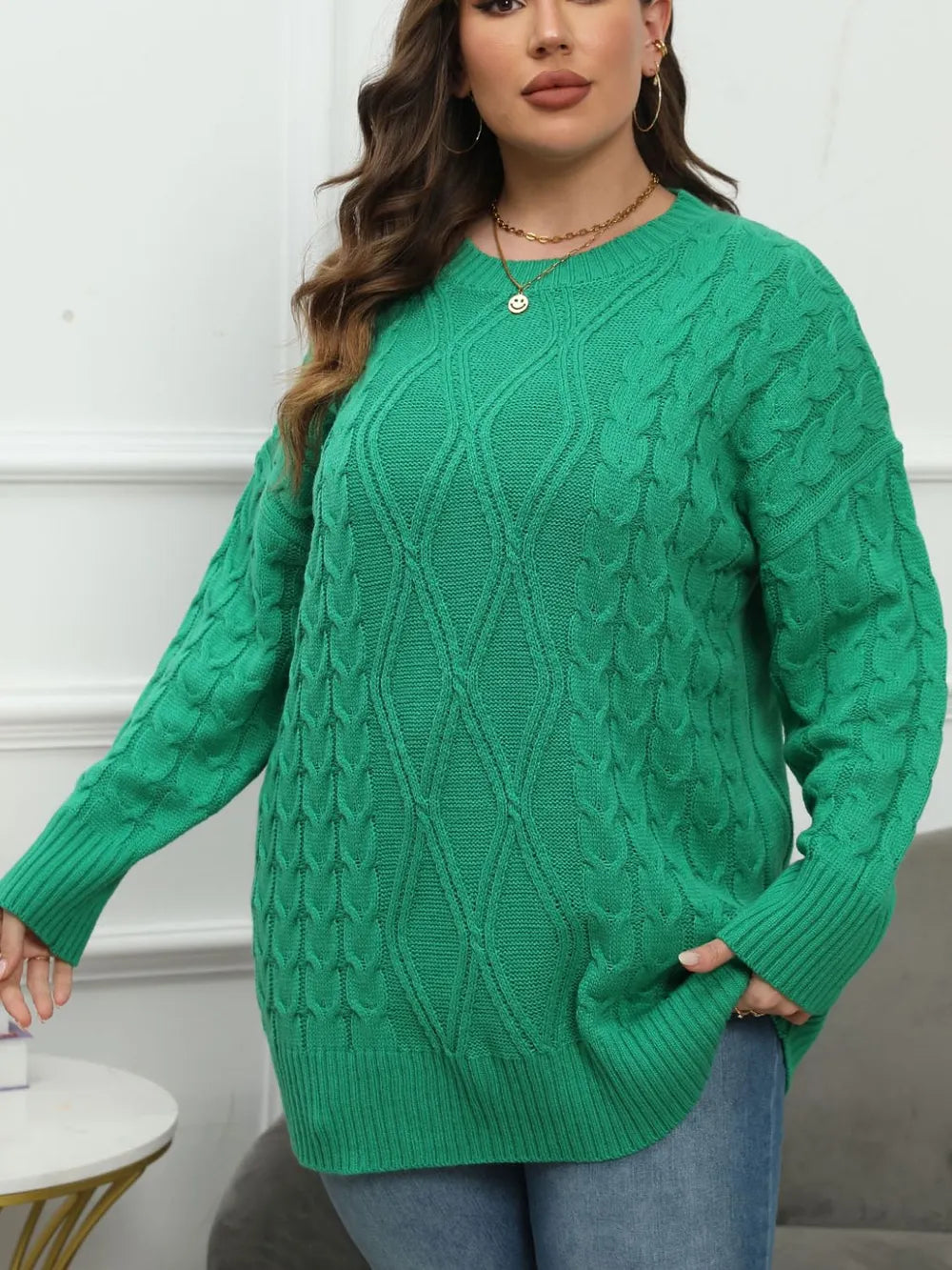 Cable longline crew neck plus size in dark green, styled on model