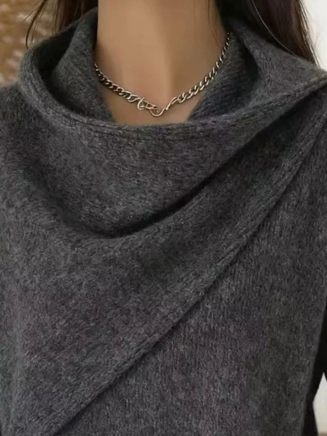 Draped diagonal cowl neck ribbed hem in gray, close-up detail