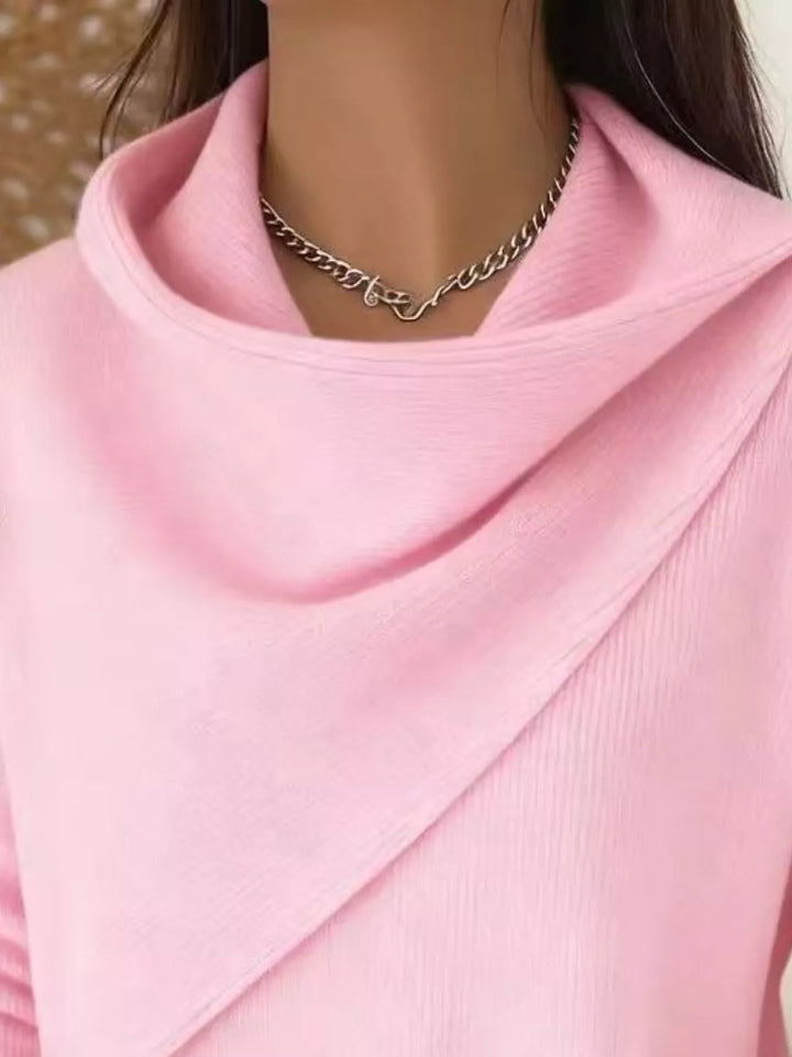 Draped diagonal cowl neck ribbed hem in pink, close-up detail