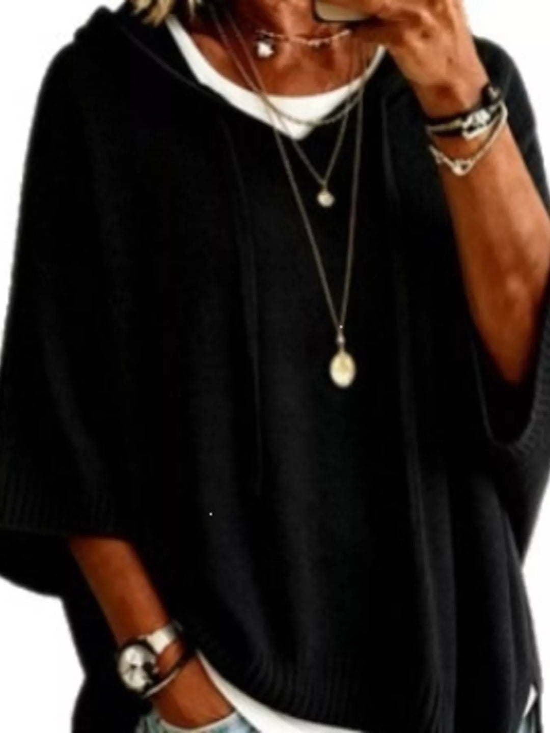 Hooded batwing elbow-length sleeves in black, close-up detail