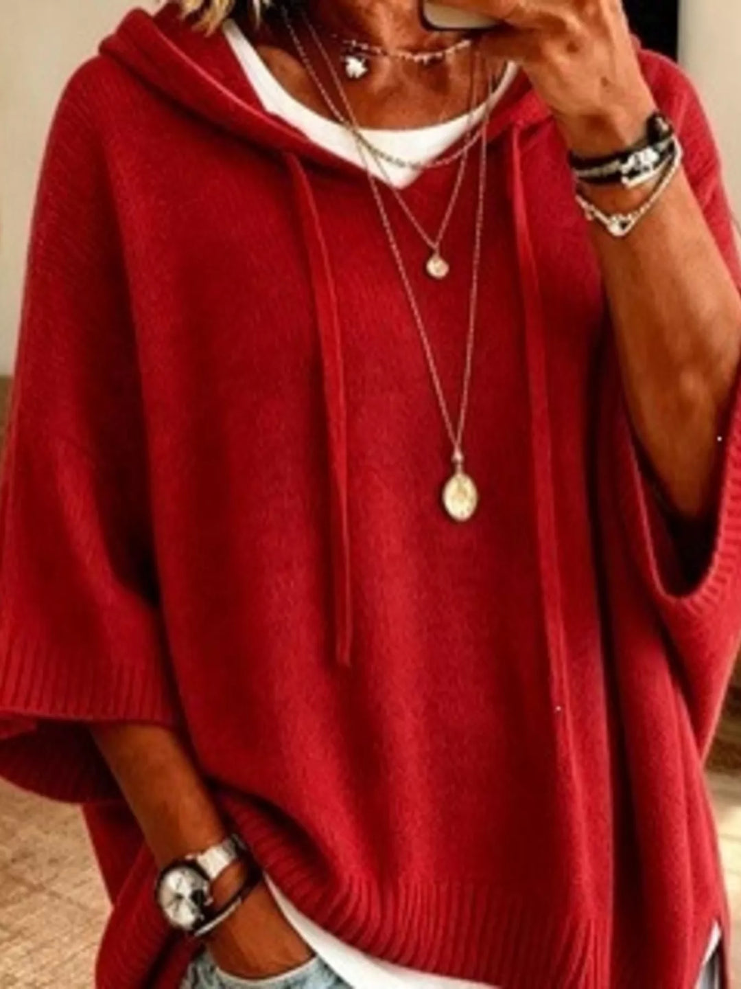 Hooded batwing elbow-length sleeves in red, close-up detail