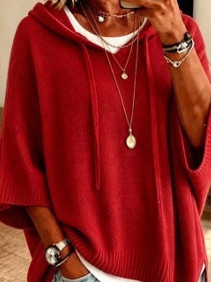 Hooded batwing elbow-length sleeves in red, close-up detail