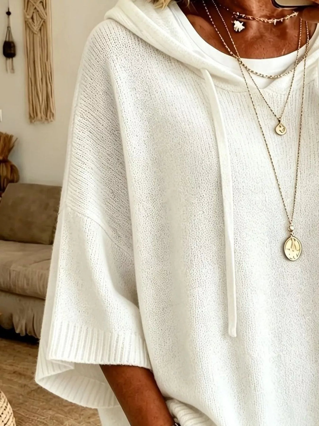 Hooded batwing elbow-length sleeves in white, close-up detail