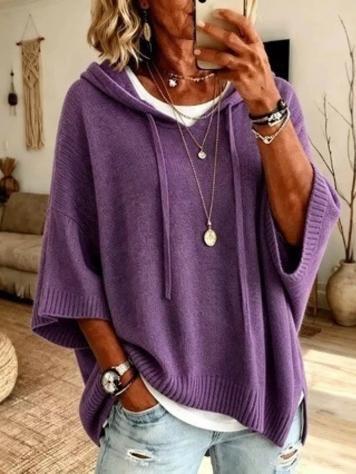 Purple hooded knit sweater with batwing sleeves and drawstrings, front view