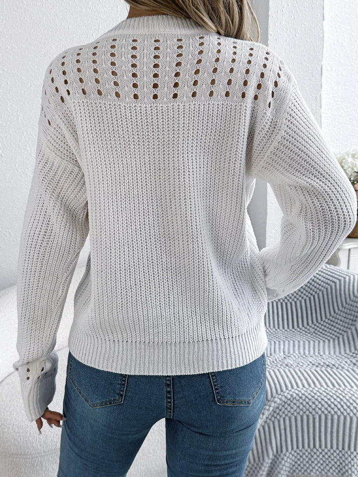 Back view of the white pullover with openwork yoke and long sleeves