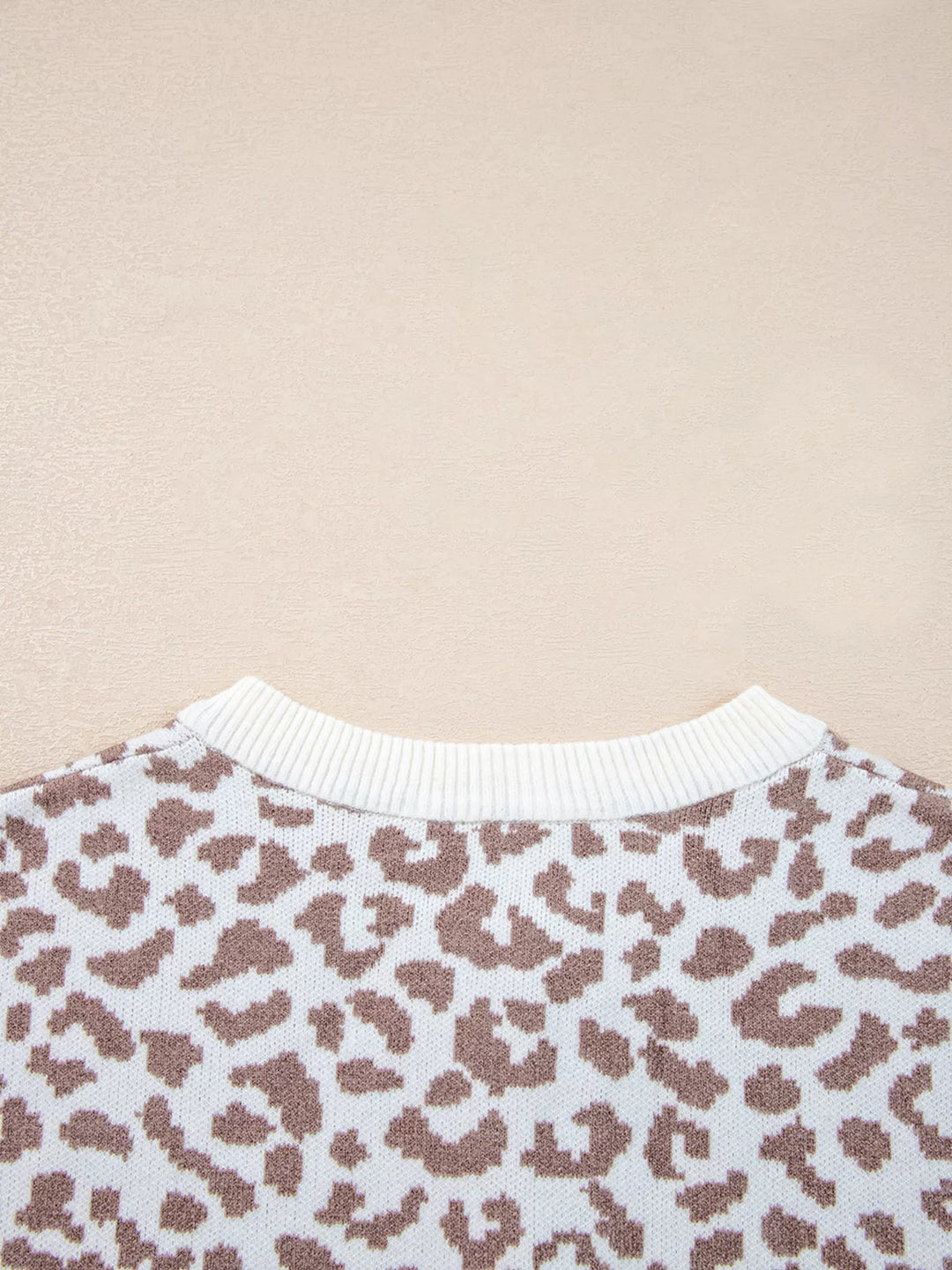 Close-up of the round neck ribbed trim on the ivory leopard cardigan