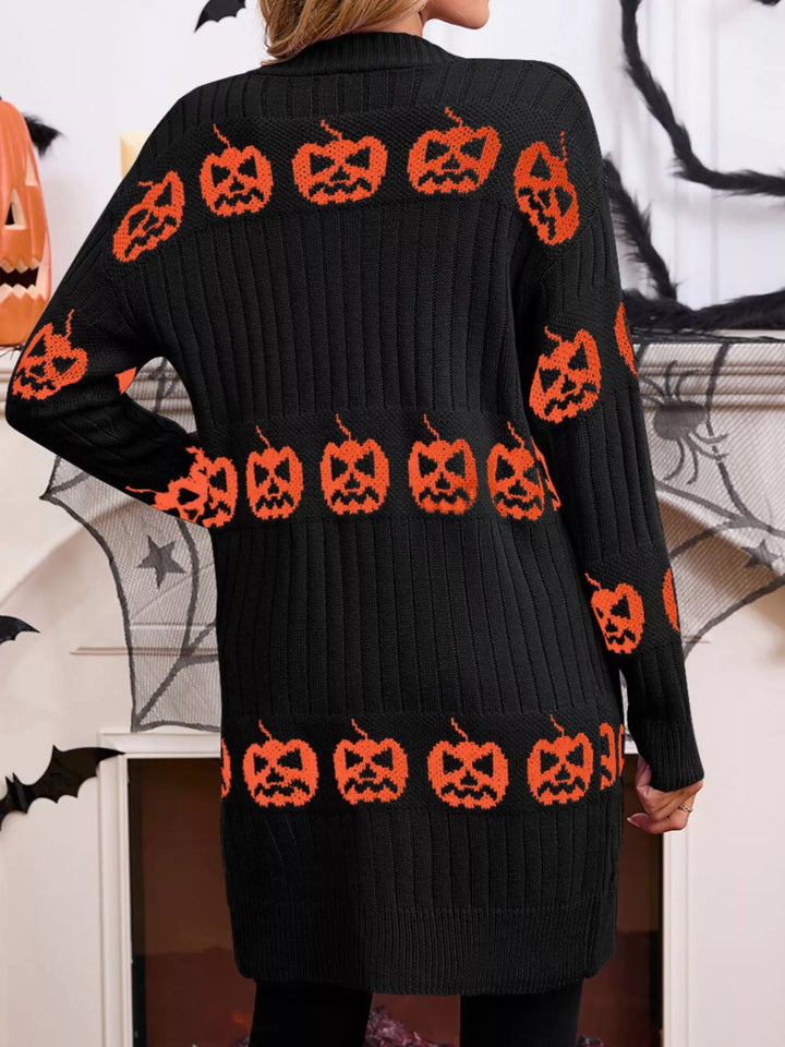 Back view of the black ribbed knit cardigan with rows of orange pumpkins