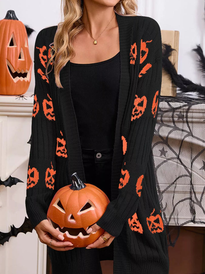 Black pumpkin cardigan worn open while holding a carved pumpkin, Halloween setting