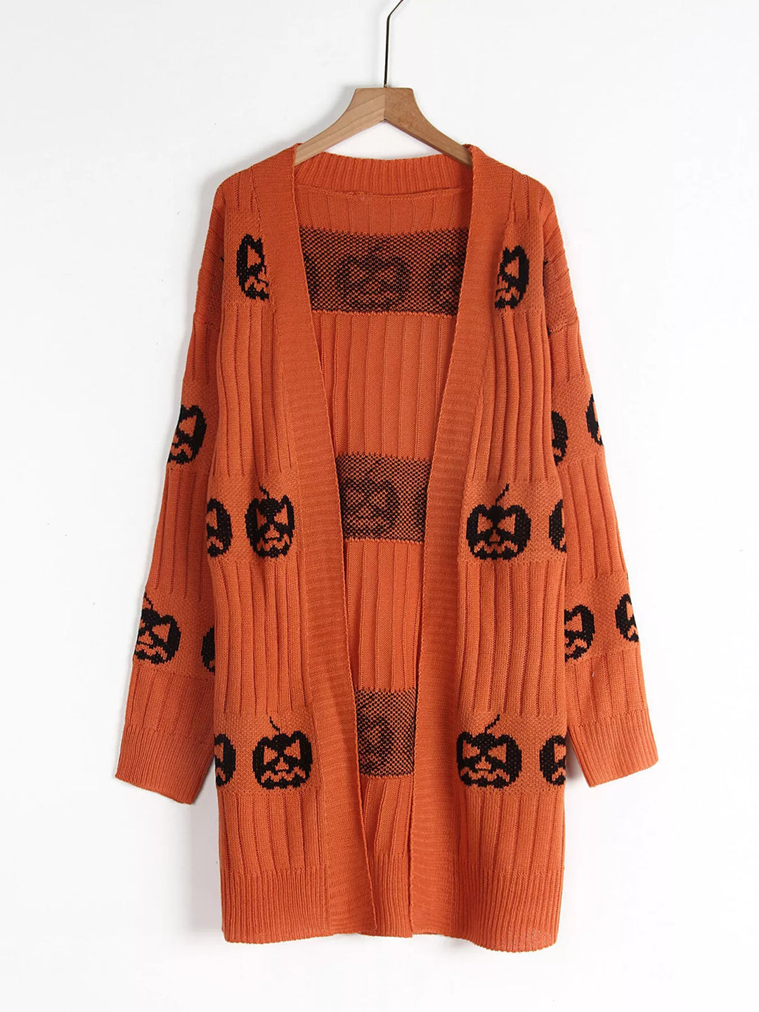 Orange open front pumpkin cardigan hanging on a wooden hanger
