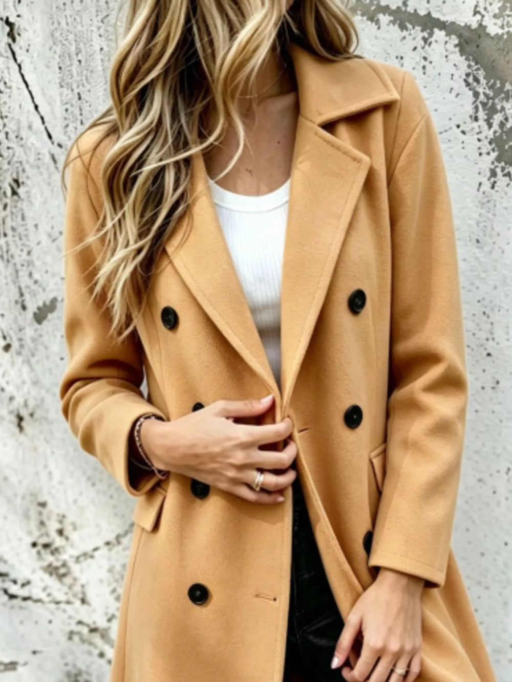 Camel double breasted coat close-up of the lapel collar and black buttons