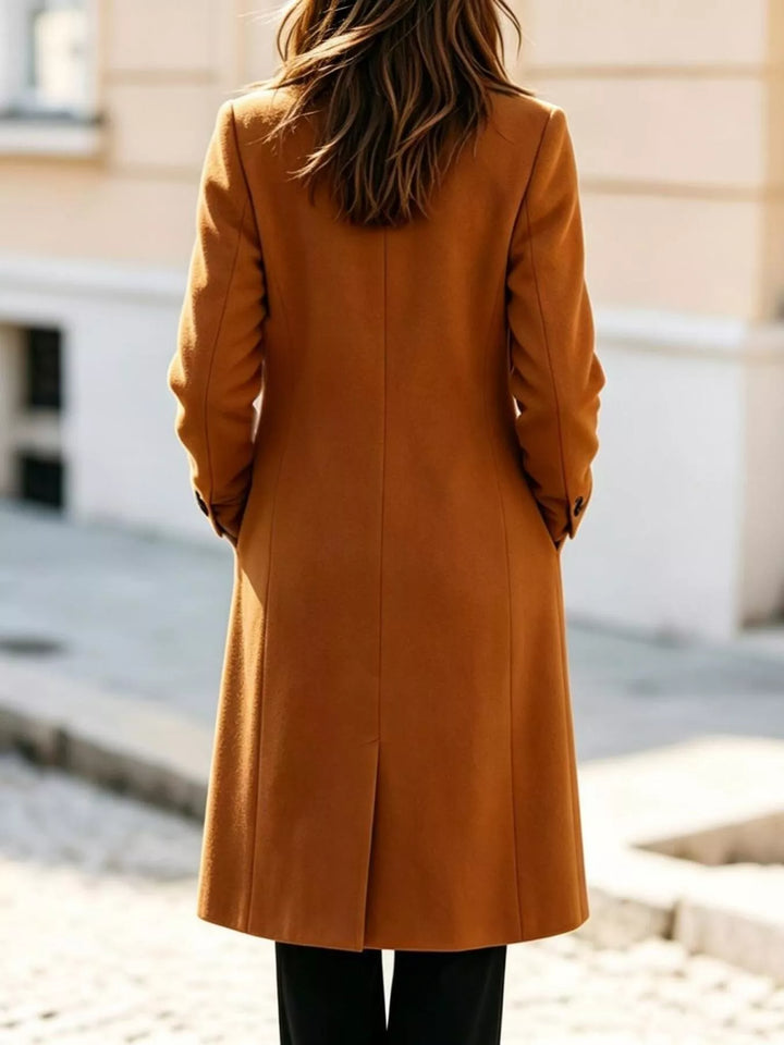 Back view of the cognac mid calf coat with a clean rear vent