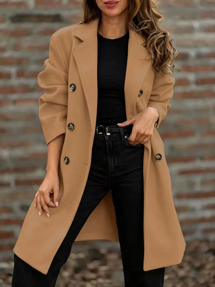 Camel longline coat with notch lapel and double breasted buttons over a black top