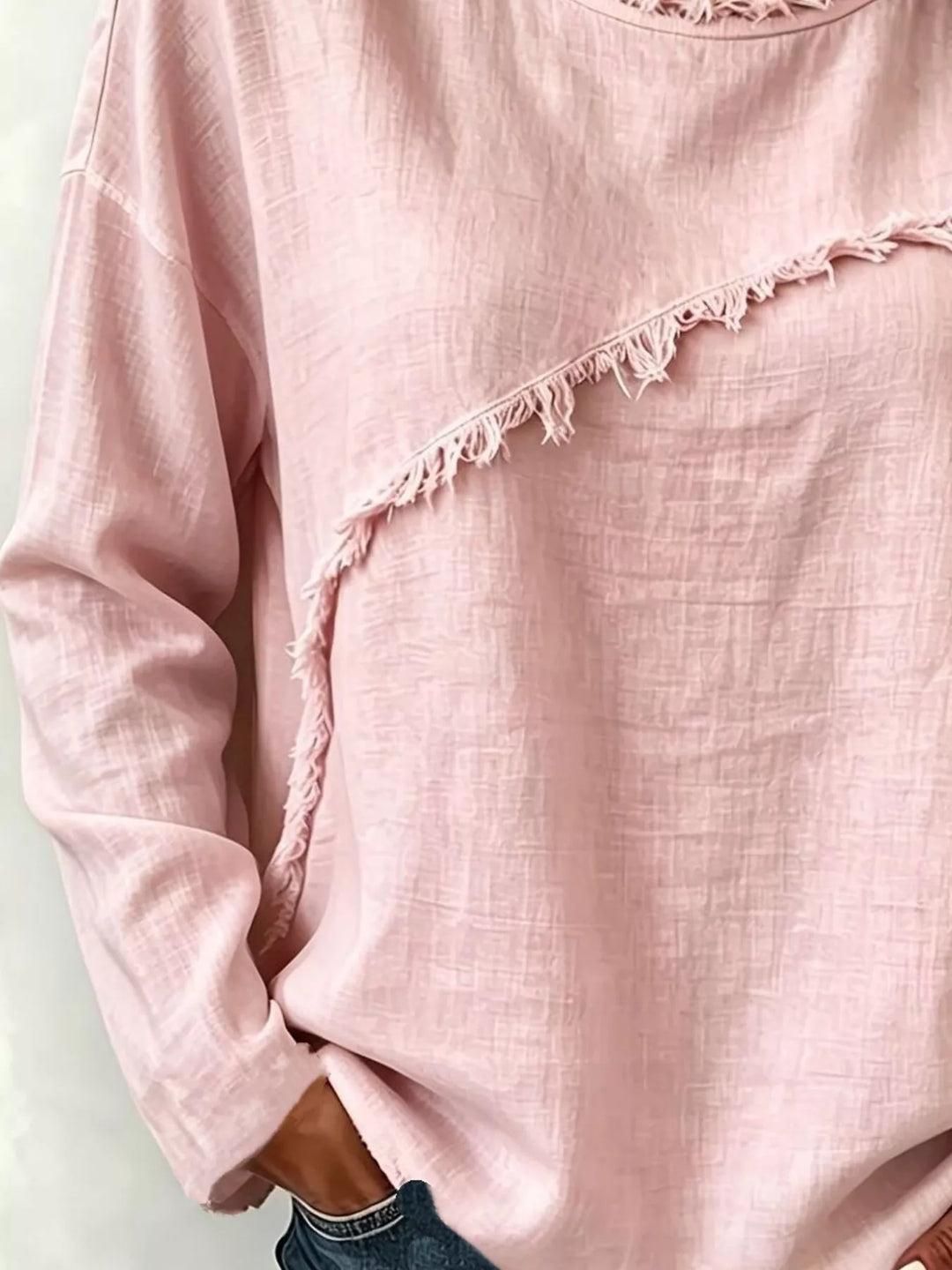 Frayed diagonal seam round neck in blush pink, close-up detail 2