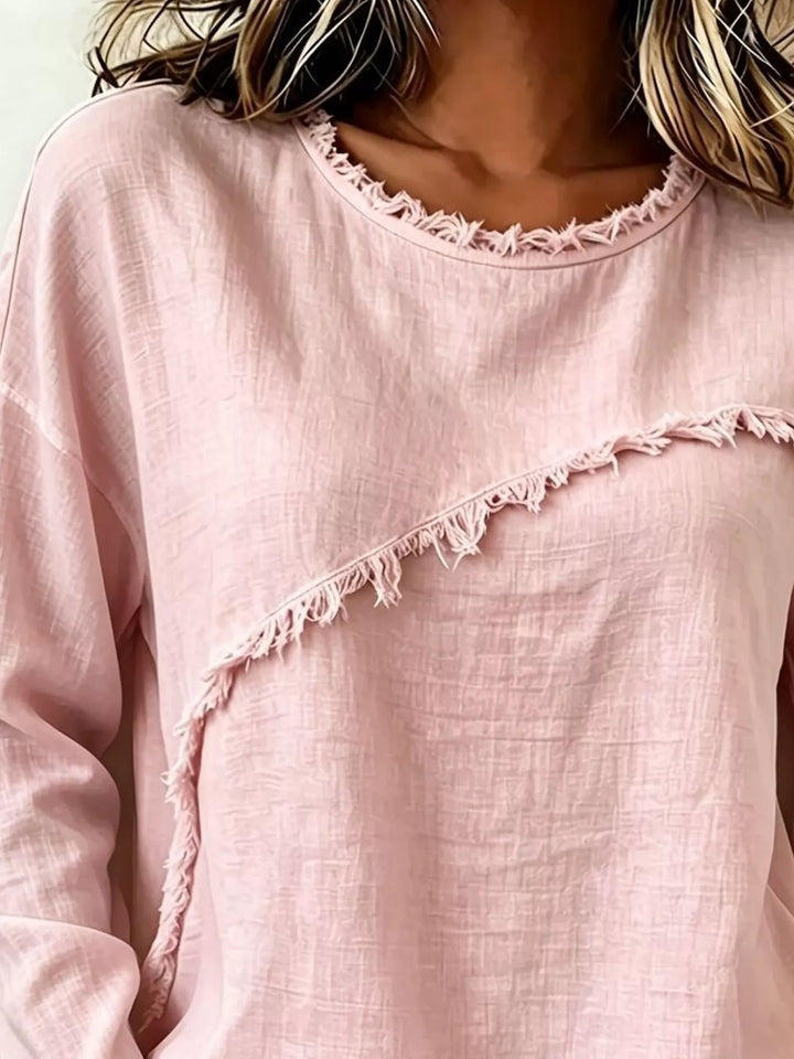 Frayed diagonal seam round neck in blush pink, close-up detail