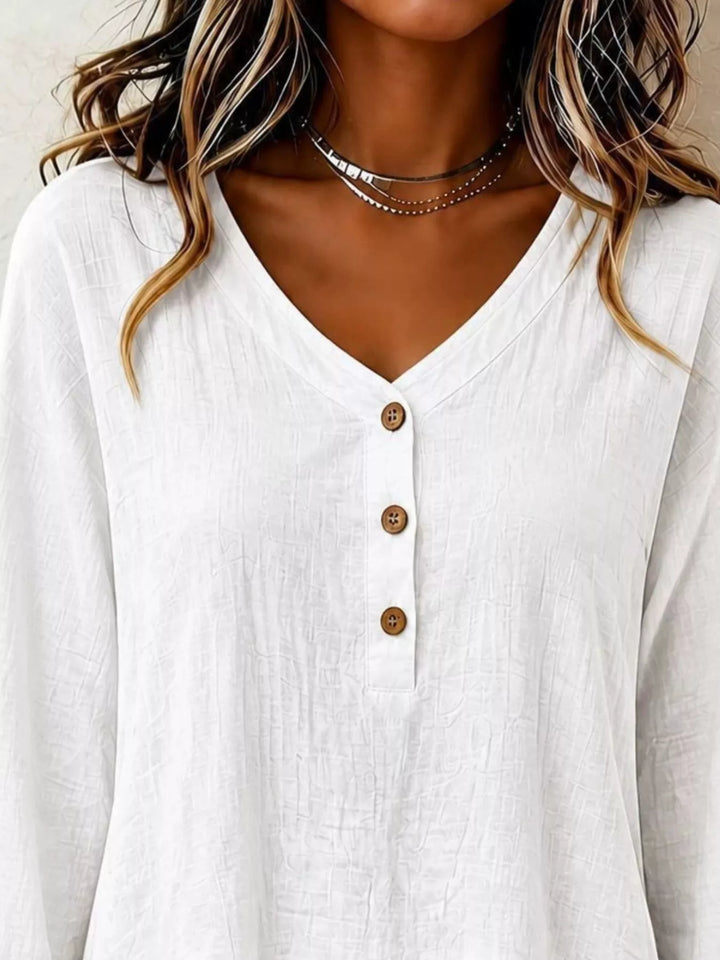 Tiered ruffle hem v-neck slub texture in white, close-up detail