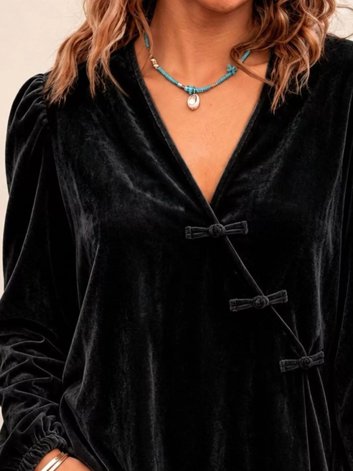 Velvet-look knot button puff sleeve in black, styled on model