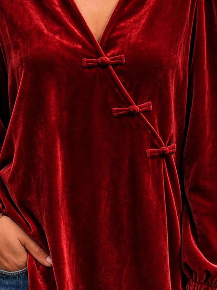 Velvet-look knot button puff sleeve in burgundy, styled on model