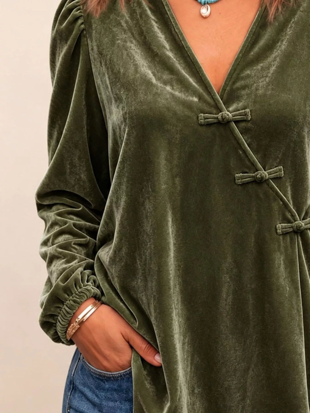 Velvet-look knot button puff sleeve in dark green, styled on model