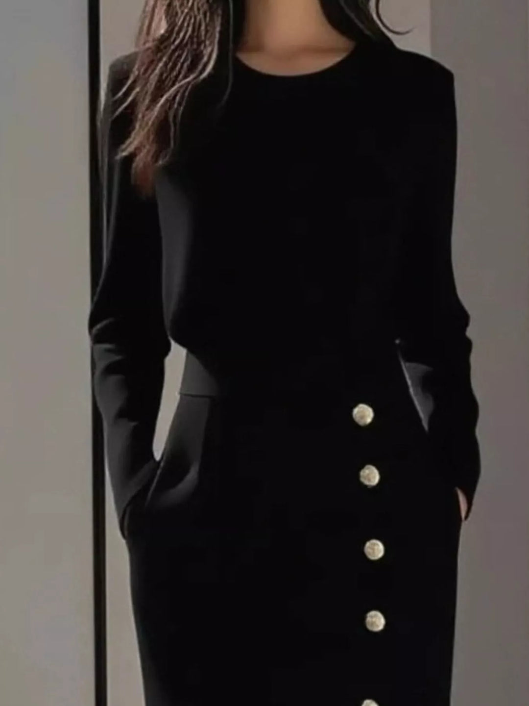 Round neck side button slit pockets in black, close-up detail