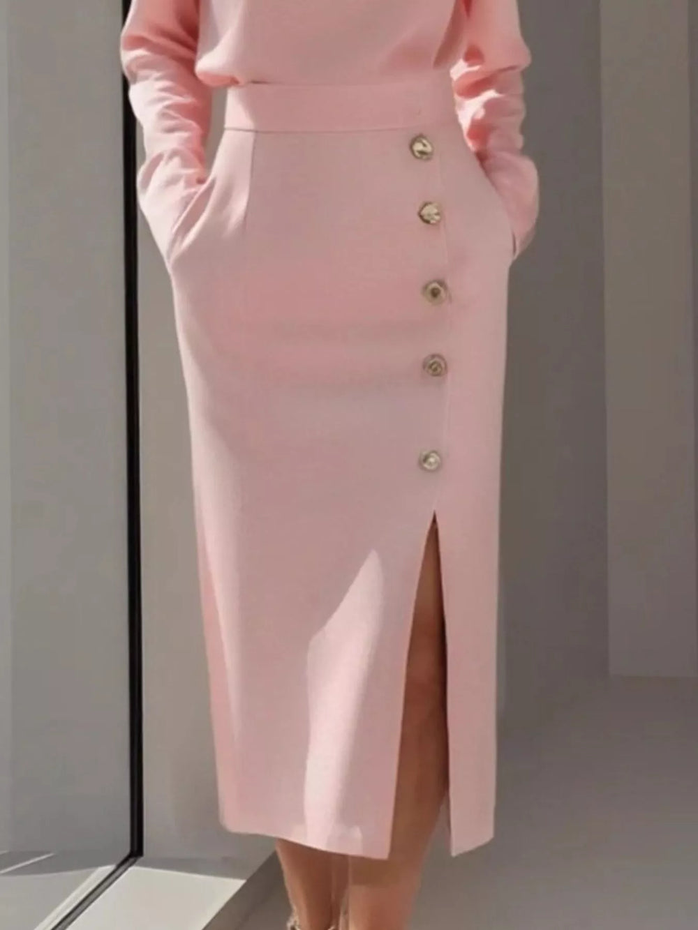Round neck side button slit pockets in pink, close-up detail