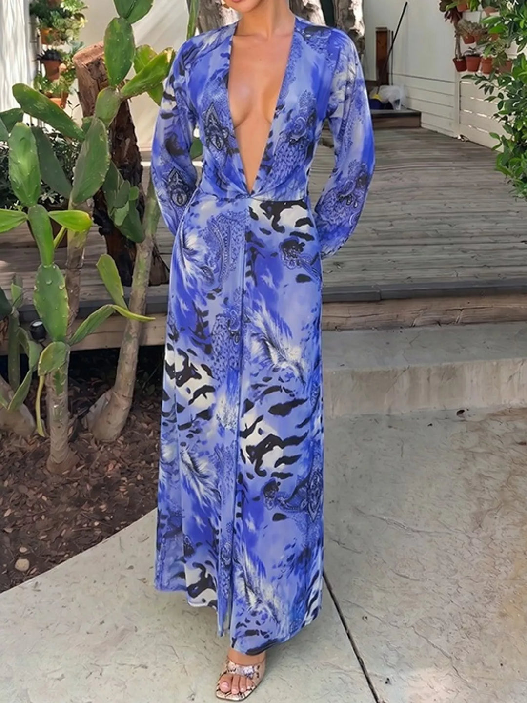 Blue maxi dress worn on a model, showing the open back