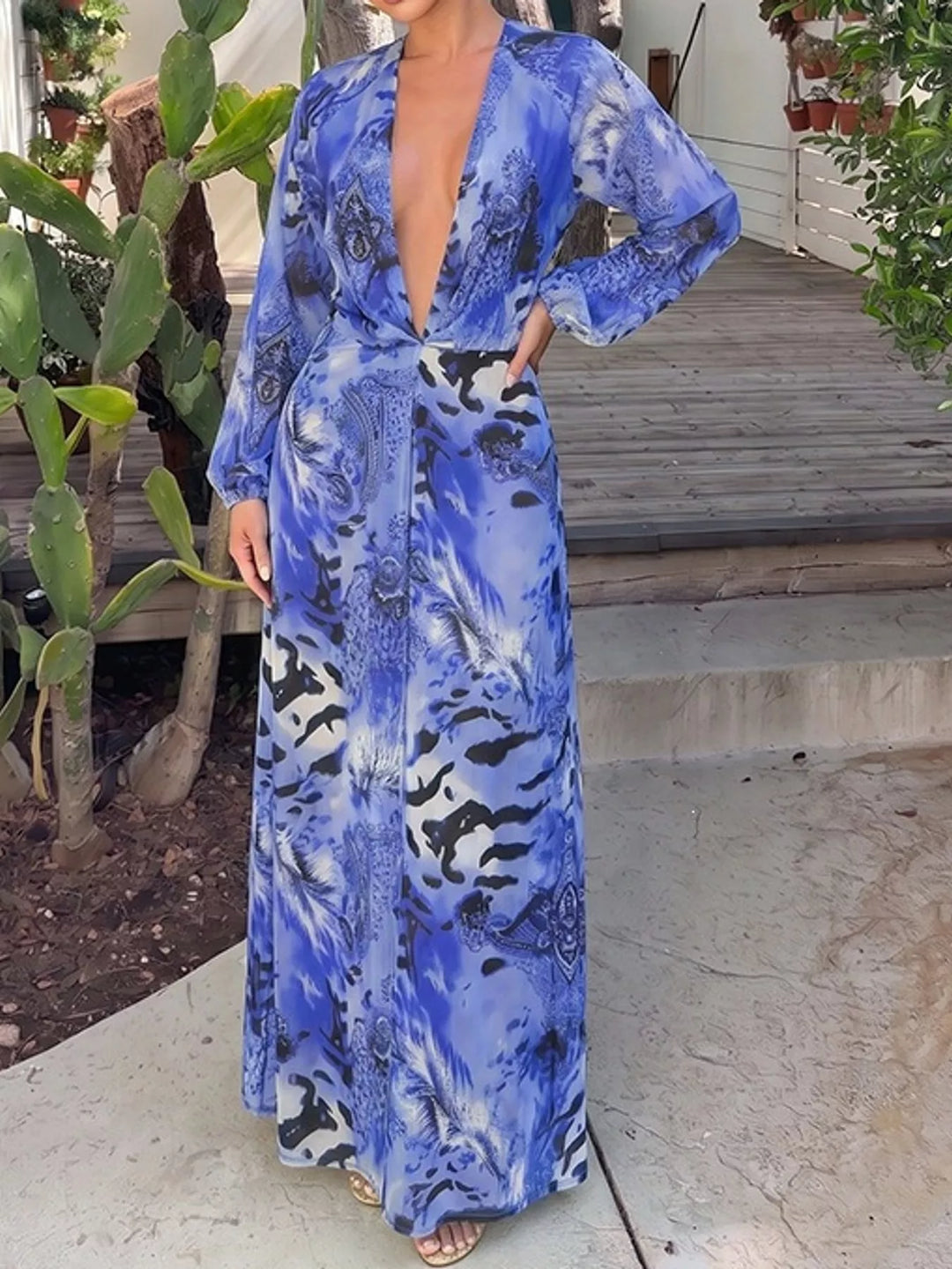 Blue maxi dress worn on a model, showing the deep V-neck