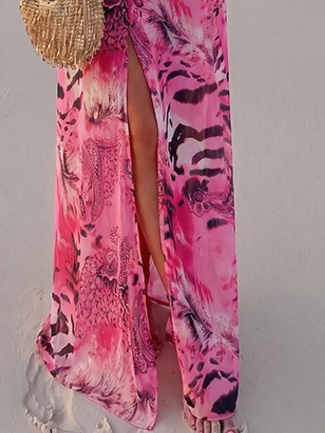 Pink maxi dress worn on a model, showing the leg slit