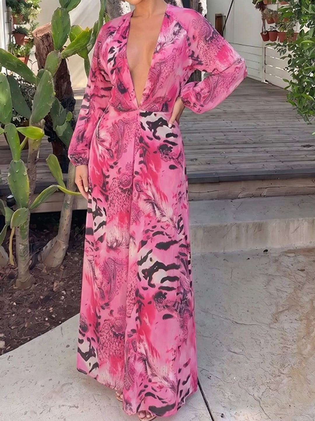 Pink maxi dress worn on a model, showing the deep V-neck