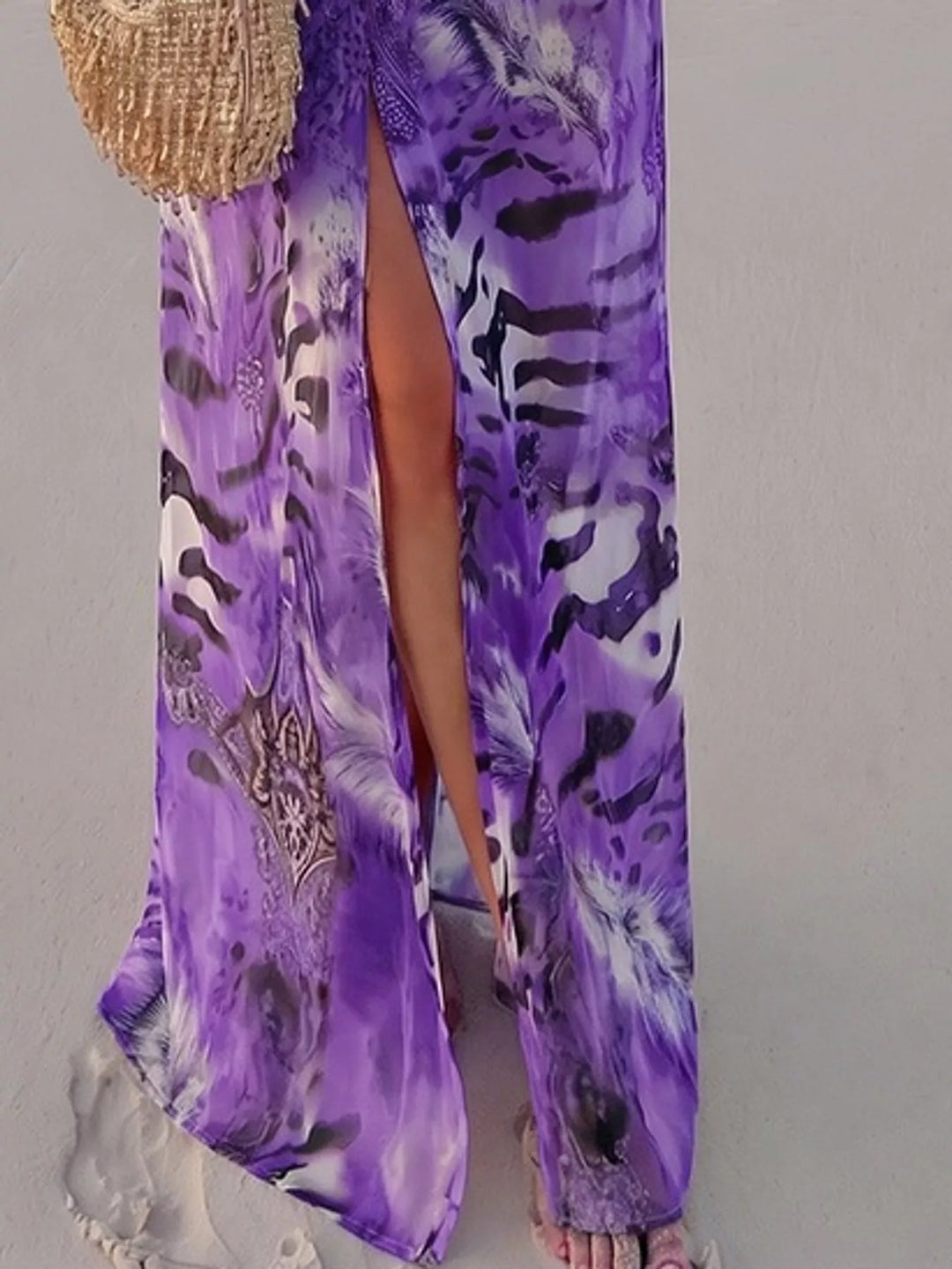 Purple maxi dress worn on a model, showing the leg slit