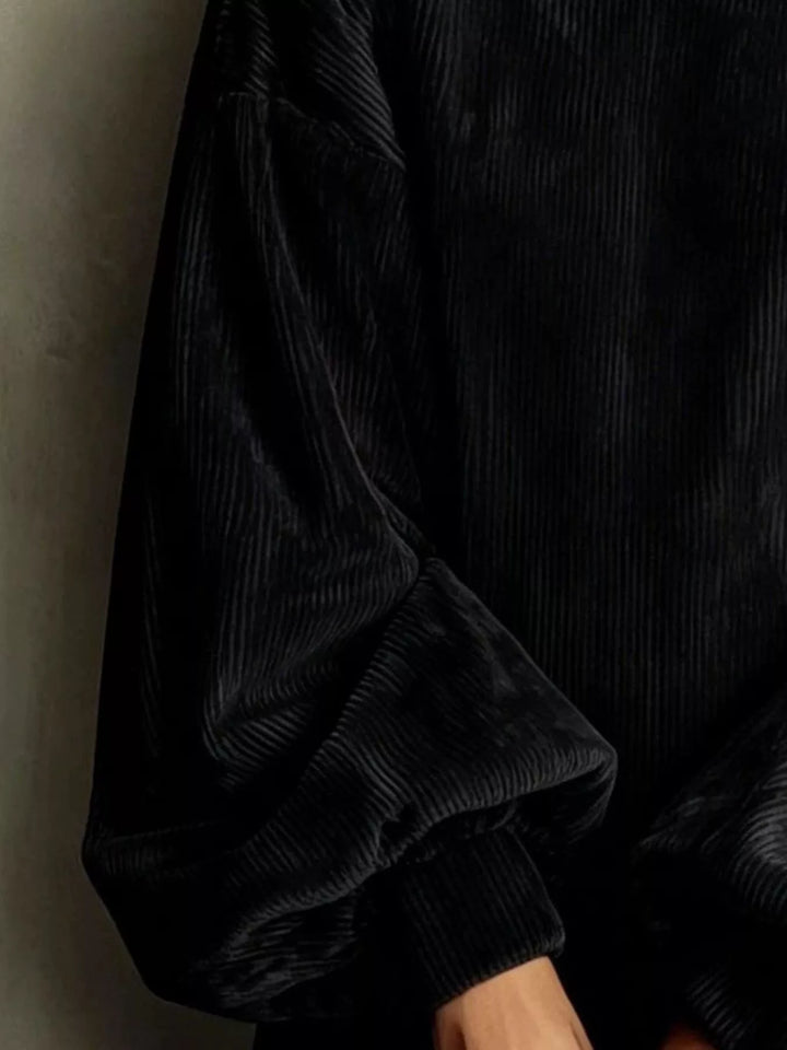 Close-up of the corded texture on the black mini dress
