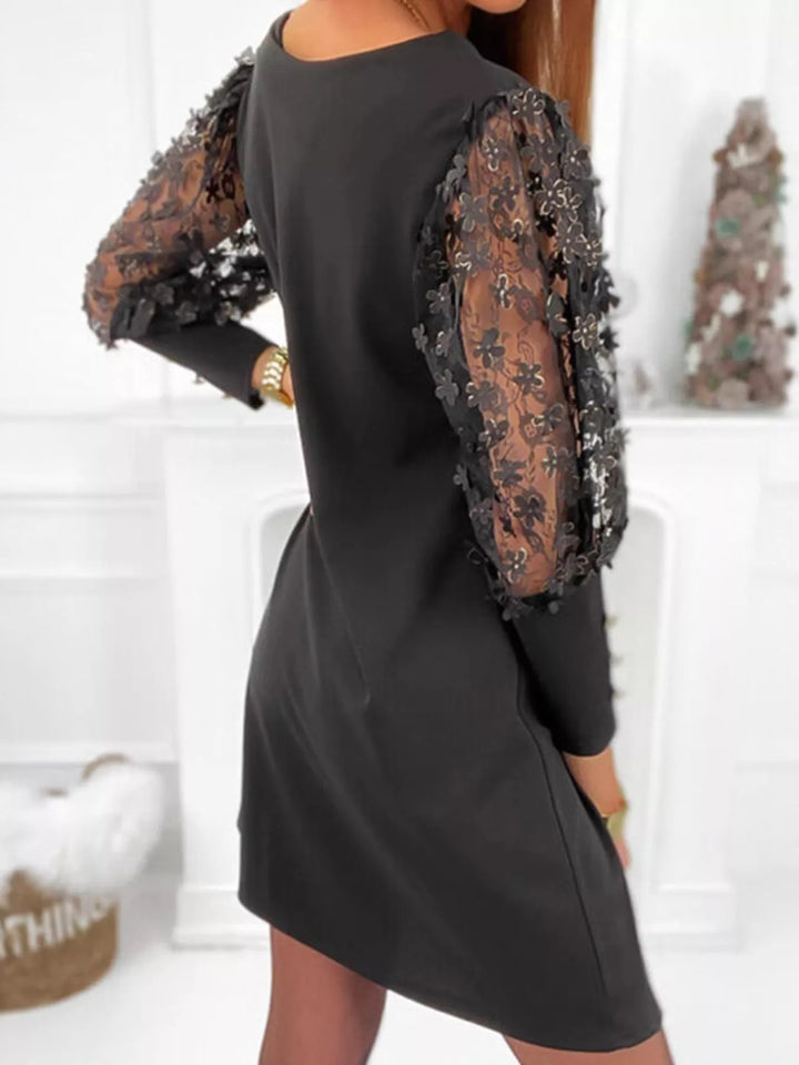 Black mini dress worn on a model, showing the button cuffs