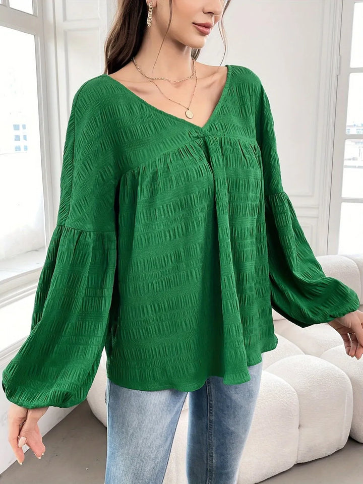 Women's long sleeve top in dark green, crinkle texture gathered yoke v-neck