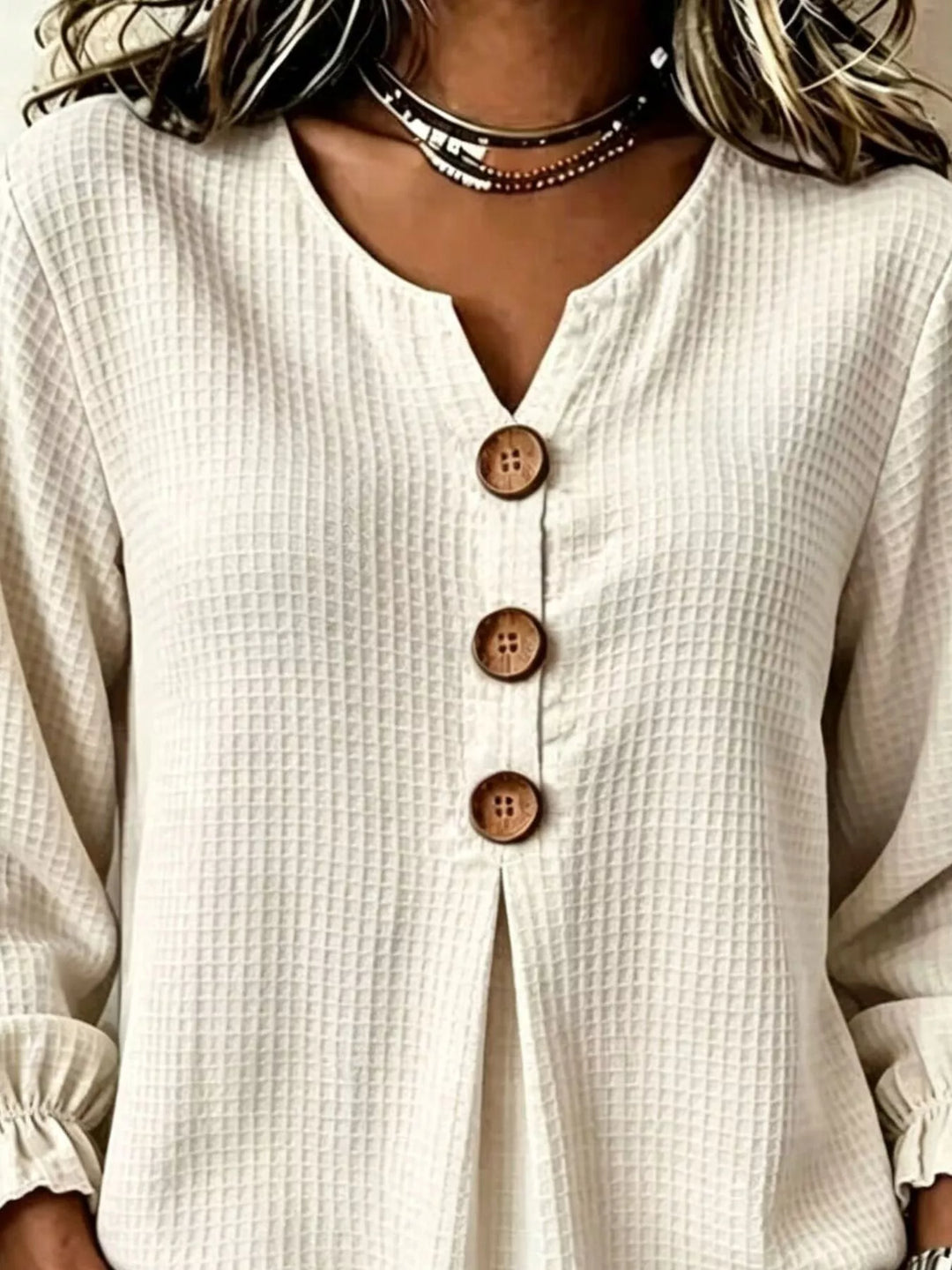 Waffle knit notched v-neck big buttons in beige, close-up detail