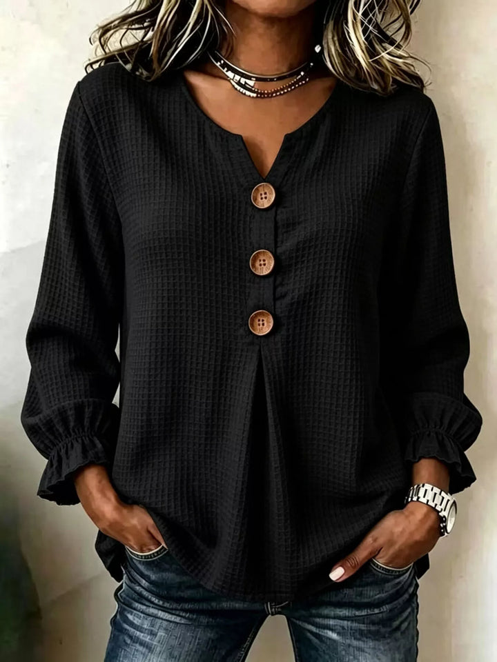 Waffle knit notched v-neck big buttons in black, front view