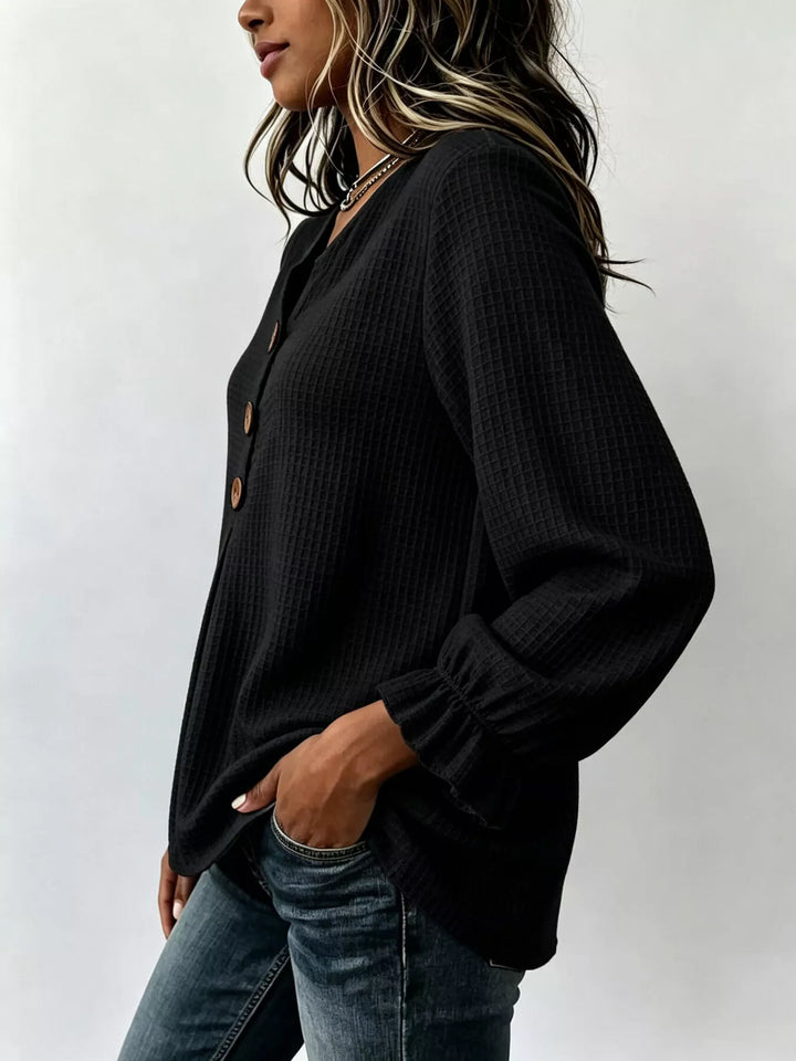 Waffle knit notched v-neck big buttons in black, styled on model 2
