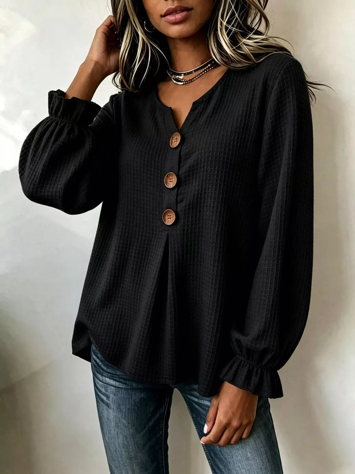 Waffle knit notched v-neck big buttons in black, styled on model