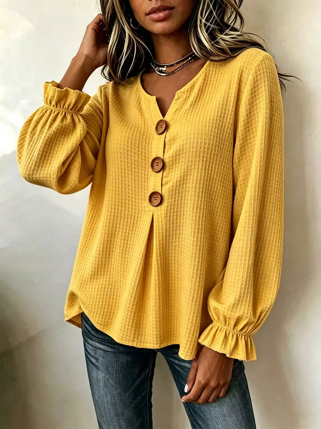 Waffle knit notched v-neck big buttons in mustard, styled on model