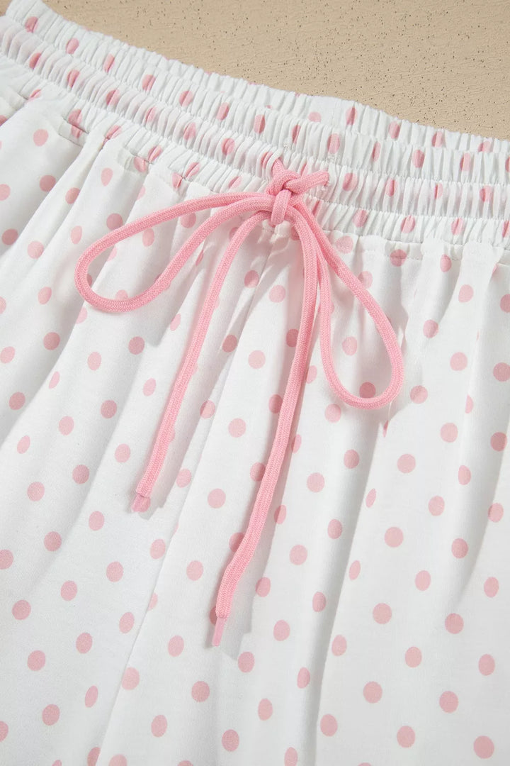 Close-up of the pink drawstring tied on the polka dot lounge pants