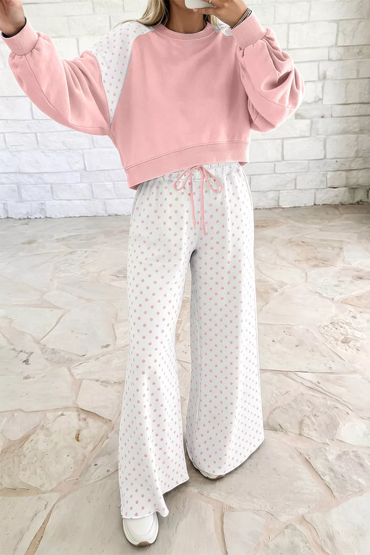 Blush lounge set with one arm raised, showing the cropped sweatshirt and drawstring pants