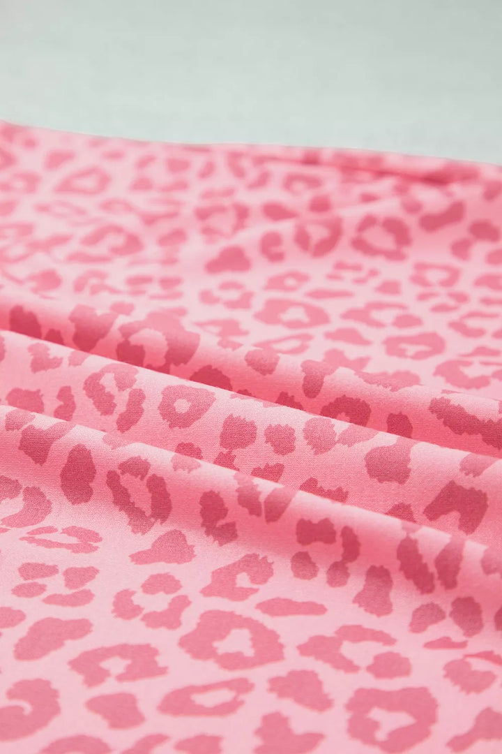 Close-up of folded pink leopard print fabric showing the pattern