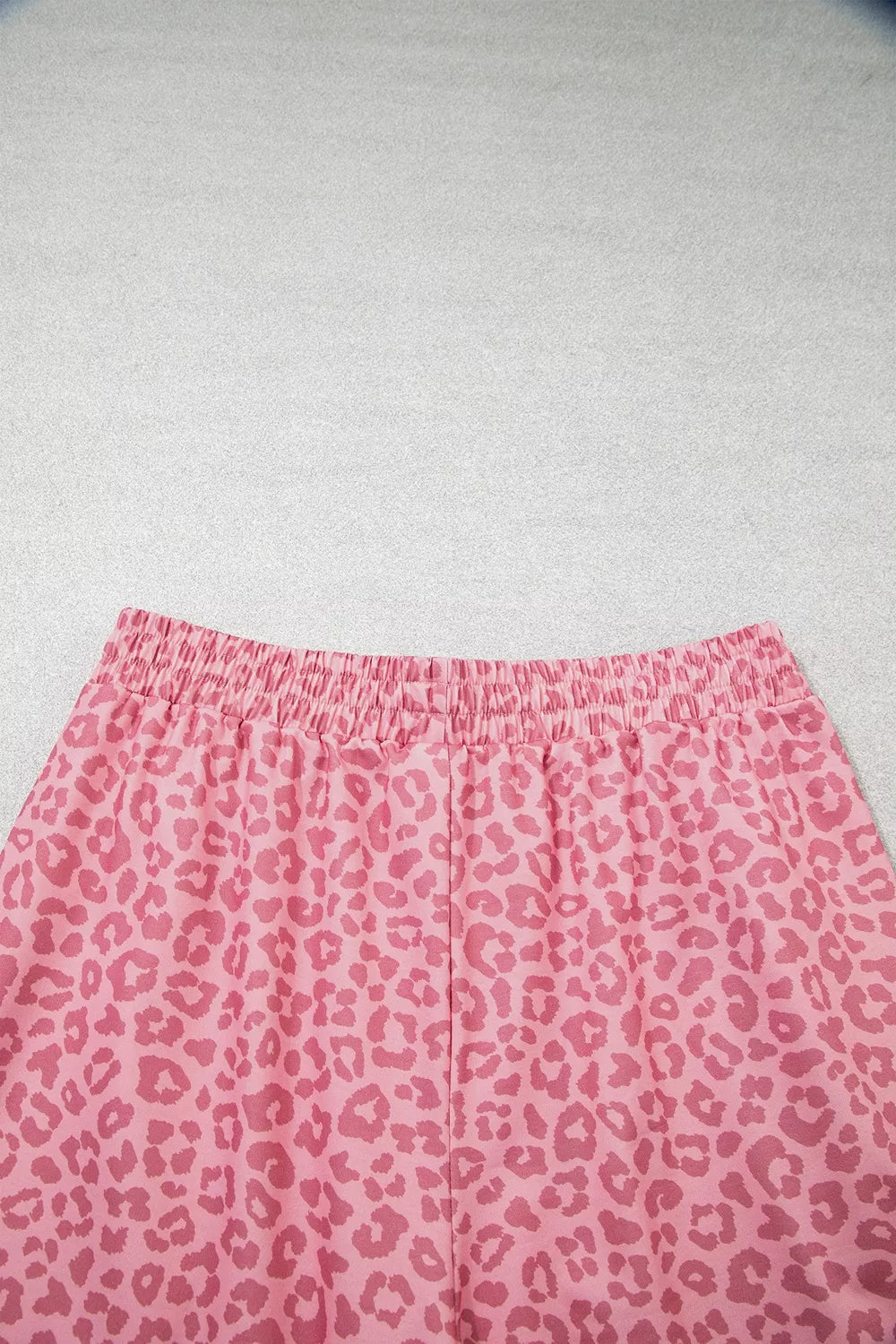 Close-up of elastic waistband on pink leopard print wide leg pants