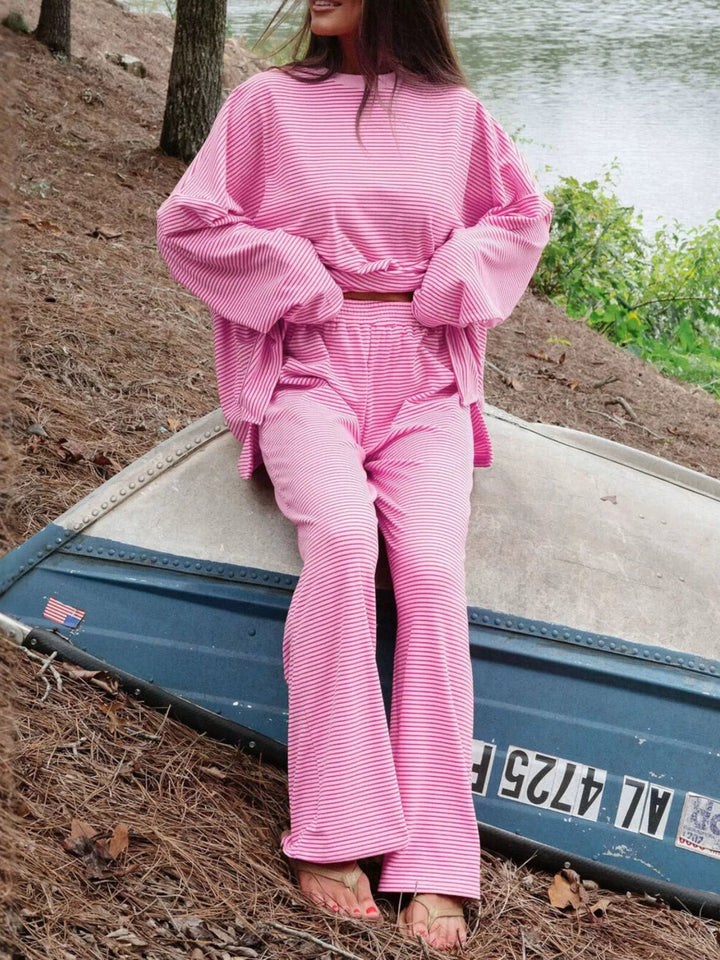 Pink lounge set worn seated on a boat near the beach