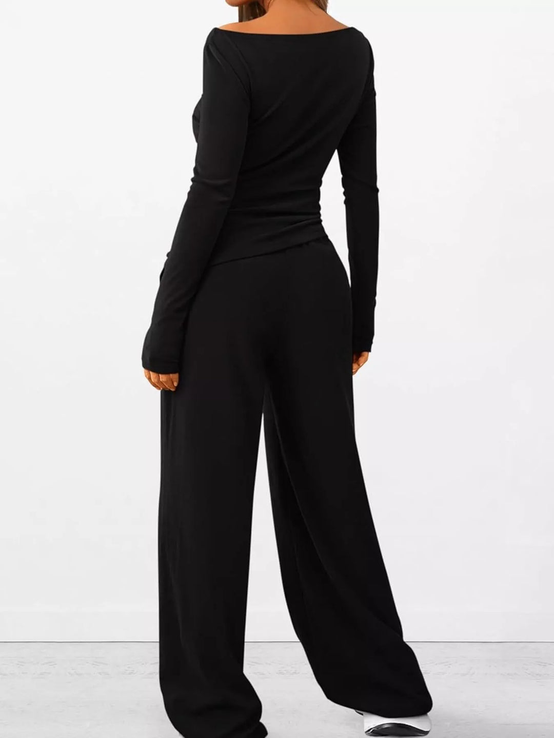 Black ribbed lounge set from a turned angle with drawstring waist pants
