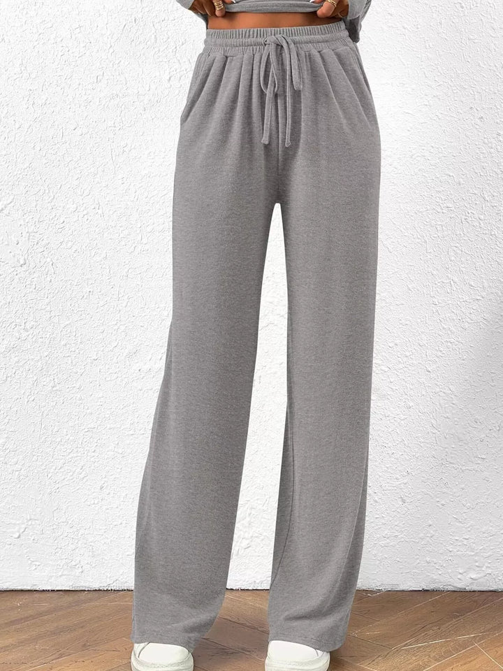 Light gray wide leg pants with drawstring waist, cropped lower view