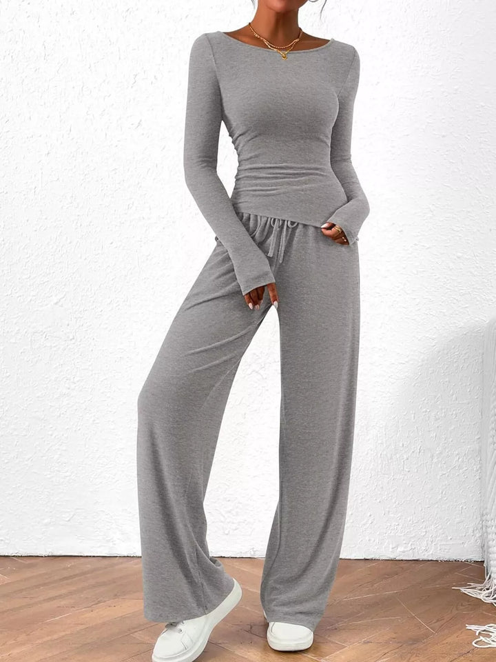 Light gray ribbed top and drawstring wide leg pants with hands in pockets