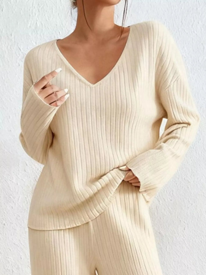 Cream v neck ribbed top, close view of the neckline and sleeves