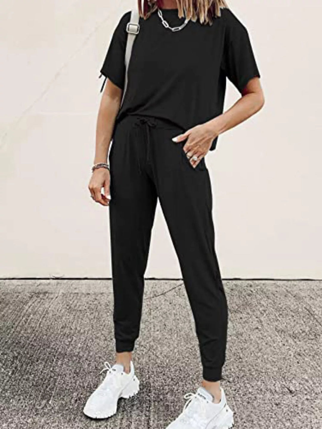 Black lounge set with short sleeve tee and jogger pants, hands in pockets