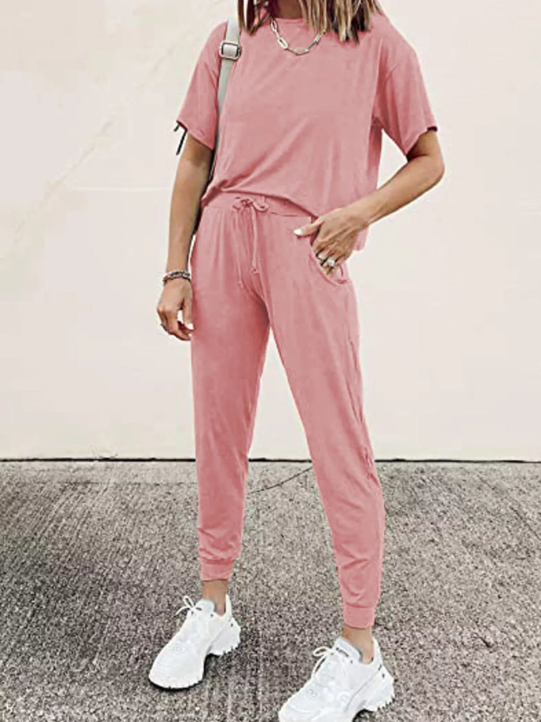 Women's lounge set in dusty pink, short sleeve tee and jogger pants with white sneakers