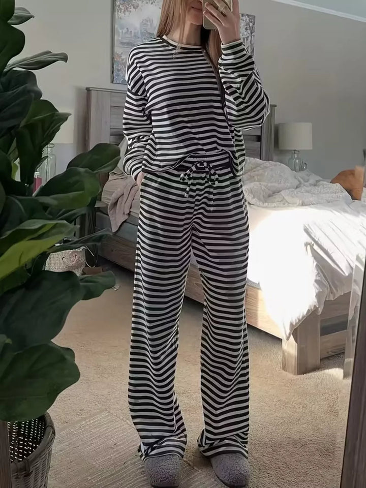 Black striped oversized top and wide leg pants set standing in a bedroom