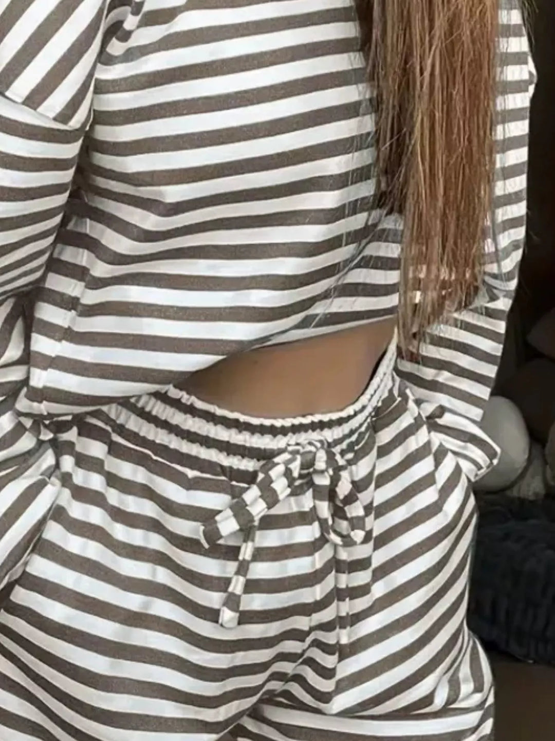 Close-up of the taupe striped top and drawstring waist of the lounge set